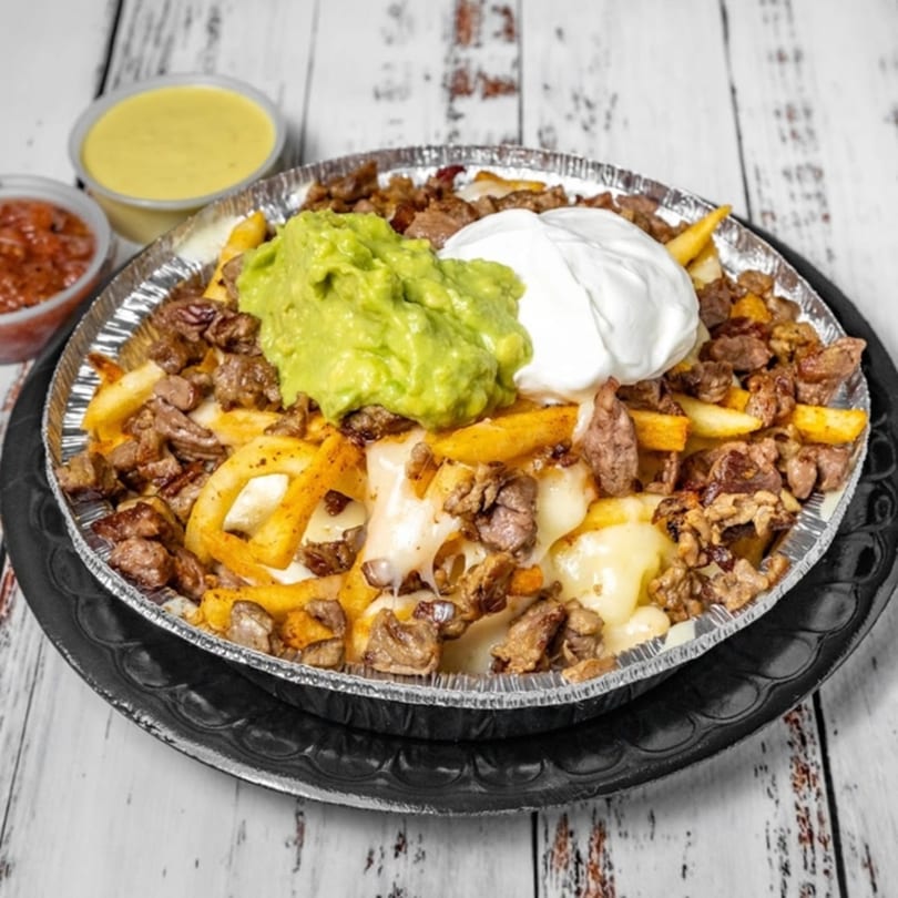 Bandeño Mexican Food's carne asada fries with guacamole, sour cream, and two dipping sauces.