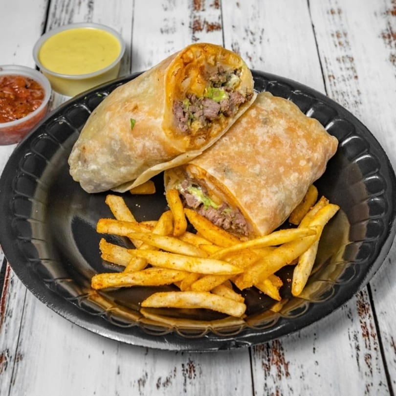 Two Bandeño Mexican Food burritos with fries, salsa, and cheese sauce on a black plate.